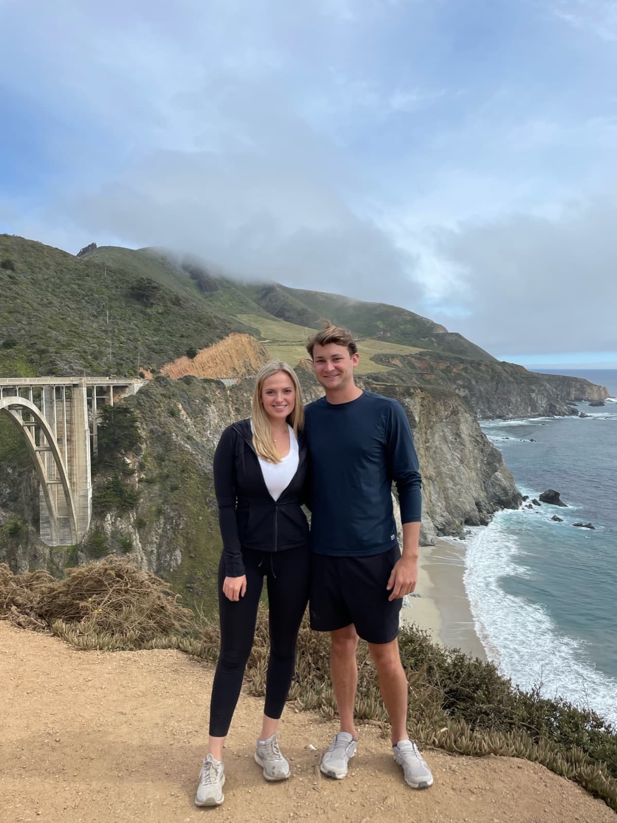 Allie and Chris above the coast at Bixby Bridge in Big Sur
